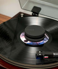 High Mass Vinyl Record Stabilizer 760 Gram Steel Weight With Anti Resonance Rubberized Coating And Protective Velvet Pad in use on turntable