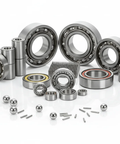 Assorted bearings and balls displayed on a white surface, showcasing various sizes and configurations of industrial bearing units.