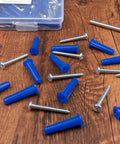 #12-16 Wall Anchors and Screws Kit 134pcs with Plastic Concrete Anchors and Galvanized Wood Screws scattered on wooden surface