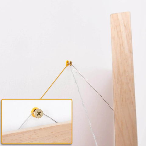 510Pcs Wall Hanging Kit with Anchors and Screws installed on wall holding frame, detailed view of screw and anchor setup.