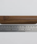 Single walnut wood drawer pull shown with ruler to highlight 157mm length, part of Walnut Wood Drawer Pulls Set Of 6 Solid Wood Furniture Handles With 5.04 Inch Hole Centers 128mm And 6.18 Inch Length 157mm 1.10 Inch Width 28mm Includes Mounting Screws For Dresser And Wardrobe Cabinets Elegant Minimalist Hardware.