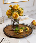Walnut Wood 18 Inch Lazy Susan Turntable Organizer on a countertop with vase of yellow flowers, books, and a bowl of apples