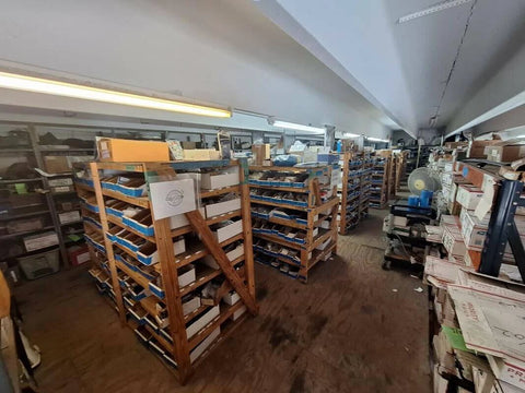 Wooden shelving with parts and components stored in a workshop or warehouse