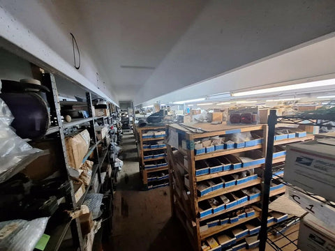 Industrial storage room with shelves full of marine hardware and parts in a warehouse setting