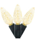 Warm White C6 LED Christmas Light Strand On Green Wire With 50 Bulbs close-up of three lit bulbs