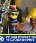 Worker using EZ Reach Flexible Straw Multi Use Lubricant For Tight Spaces By WD-40 14.4 oz spray can to lubricate equipment