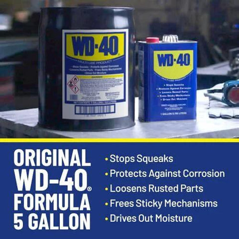 Heavy Duty Multipurpose Lubricant Spray For Tools And Equipment That Cleans Grease Grime And Dirt Penetrates Stuck Parts Displaces Moisture Prevents Rust And Corrosion Degreases Tar And Adhesives In A 1 Gallon Can From The Trusted WD-40 Brand; original WD-40 formula, 5 gallon can in workshop.