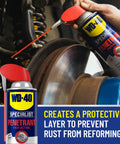 WD-40 Specialist fast rust relief penetrant with Smart Straw spraying rusted metal surface in workshop.