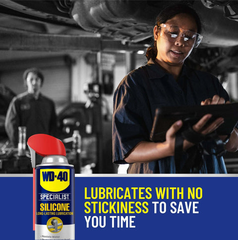 WD-40 Specialist Silicone Lubricant with SMART STRAW SPRAYS 2 WAYS, 11 OZ can in workshop, worker using tablet