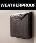 Black weatherproof mailbox mounted on a wall covered in snow and moisture droplets, demonstrating durability and resilience.