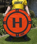 Individual holding Weighted 3 Foot UAV Drone Landing Pad Fits Matrice 4E Mini 4 Pro Mini 3 Pro Mavic Spark Durable No Stakes Required