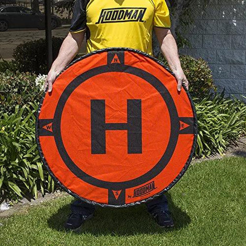 Individual holding Weighted 3 Foot UAV Drone Landing Pad Fits Matrice 4E Mini 4 Pro Mini 3 Pro Mavic Spark Durable No Stakes Required