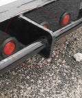 Close-up of installed Two Pack Weld On Trailer Ramp Gate Hinge Holder Bracket For Dump Trailers Fits One And A Half Inch Shaft Made From Low Carbon Steel With Plain Finish Includes Three Eighth Inch Holes And One And Five Eighth Inch Mounting Holes For Ramp Hinges on a trailer frame.
