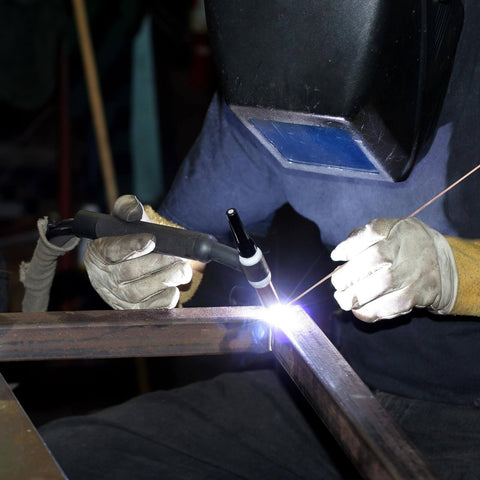 Person using Forty Pack Phos Copper Brazing Rods BCuP-2 with welding torch on metal, protective gear visible