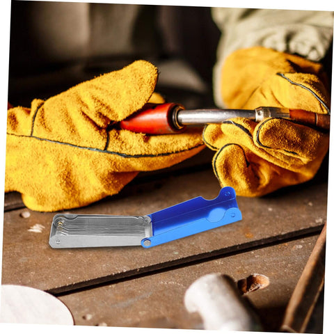 Close-up of a worker using a torch with a 13-Piece Stainless Steel Welding Tip Cleaner Kit with Aluminum Case nearby.