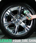 Hand holding Ultra Wet Tire Dressing Spray Delivers Extreme Shine With Non Greasy Silicone Formula near shiny car wheel.