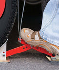 Foot installing OneStep Wheel Chock Double Pack For Tandem Axle Trailers And RVs, 16 to 24 Inch Long, no kneeling required