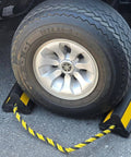 Heavy Duty Wheel Chocks With Ropes For Trucks And Trailers, Oil Resistant Rubber, Reflective Stripes, shown in use with tire