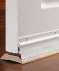 36 in. White Aluminum and Vinyl Flex-O-Matic Screw-on Door Sweep installed on wooden floor, sealing draft under a door.