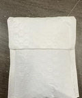 White padded envelope on a dark surface