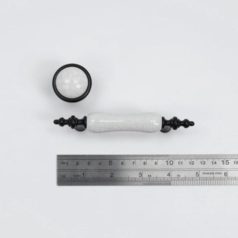 Eight Piece Crack Pattern White Ceramic Cabinet Pulls And Drawer Knobs Set in Antique Black with ruler for scale