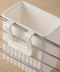 White cutlery drying rack utensil drainer clipped to metal dish rack, multi-porous design for sink storage of spoons and forks.