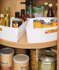 Quarter Wedge Lazy Susan Turntable Organizer With Handle In White Made From Recycled Plastic for pantry storage, filled with cans and bottles.