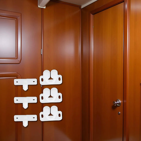 Three Pack White Marine Boat Door Catch Sets With Ball Roller Latches And Spring Back Plates on wooden paneling.