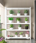 White metal shelving unit with potted plants on a patio, showcasing greenery and flowers in a neat arrangement.
