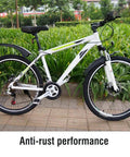 White mountain bike showcasing anti-rust performance on a garden path