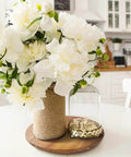 18 inch acacia wood lazy susan cabinet organizer with flowers and decorative items on a table in a kitchen setting.
