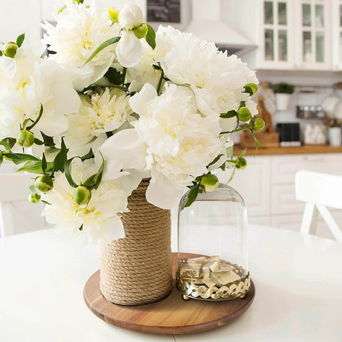 16 inch acacia wood lazy susan cabinet organizer with white flowers and decorative glass on a dining table