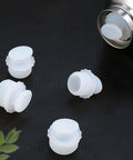 White Silicone Spiral Screw Thermal Sealed Stopper for home vacuum flasks and water bottles, shown with multiple stoppers and flask