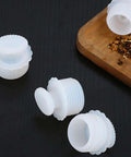 White Silicone Spiral Screw Thermal Sealed Stopper For Home Vacuum Flasks And Water Bottles Durable Reusable Bottle Plug On Black Surface