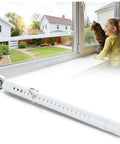 Heavy Duty Adjustable Sliding Door Security Bar For Home And Travel Anti Pry Door Stopper in white on window ledge with child and cat