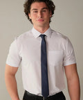 Man wearing Slim Fit Short Sleeve Performance Dress Shirt For Men White 4 Way Stretch comfort with navy tie, suitable for office and travel.