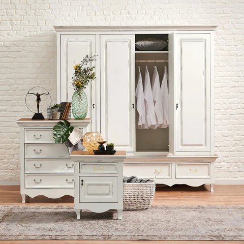 White wooden dresser and wardrobe in room with plants and decor