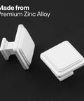 Two white cabinet knobs from the 10 Pack Zinc Alloy Drawer Knobs, square design for kitchen cabinets and drawers, on black background.
