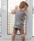 Toddler standing against a window with 10 Pack Sliding Window Sash Locks Cam Action White For Vertical And Horizontal Sliding Windows Double Hung Window Sash Lock Set Left Or Right Opening Enhances Security And Prevents Forced Entry installed for security.