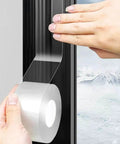 Applying Window Sealing Tape 2IN x 33 FT Draft Isolation No Residue Removable Adhesive to window frame with snowy view.