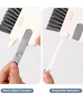 Close-up of 3-In-1 Removable Window Slot Brush With Hidden Scraper showcasing brush and hidden tweezers for cleaning window grooves.