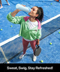 Woman drinking from a 26 oz insulated stainless steel water bottle with a 2‑in‑1 straw and spout lid on a tennis court
