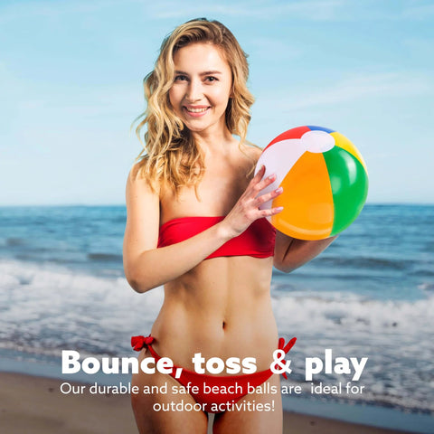 Woman holding a rainbow inflatable beach ball from the 12-Pack 12“ Beach Balls - Bulk Classic Beachball Inflatable Swimming Pool Toys set on the beach.