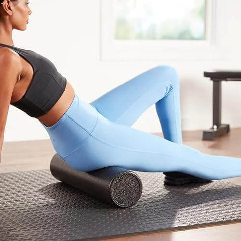 Person using High Density Foam Roller For Exercise And Recovery 18 Inches Black With Durable Polypropylene Core in a workout setting