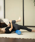 Person using Pro Roller Soft Density EVA Foam Roller For Physical Therapy Pilates Yoga And Muscle Recovery 36 Inch Blue for stretching.