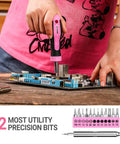 Woman using Pink Tool Kit For Women 42 Piece Home DIY Set For Repairs And Woodworking Projects on circuit board with precision bits