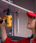 Person using a yellow power drill to repair kitchen cabinet, relevant for use with 113 Piece Bolts Nuts And Washers Assortment Kit Galvanized Iron Hardware Set For Home Repair.