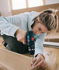 Person using drill with 4 Pcs Ball End Hex Screwdriver Bits 4mm H4.0 with 1/4 Inch Hex Shank for assembly on wooden floor