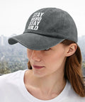 Woman wearing washed distressed baseball cap for women with adjustable strap, comfortable fit and versatile style in light grey.
