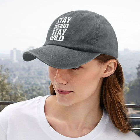 Woman wearing washed distressed baseball cap for women with adjustable strap, comfortable fit and versatile style in light grey.